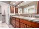 Bathroom featuring double sinks, granite countertops, and wood cabinets at 9430 S 47Th Pl, Phoenix, AZ 85044