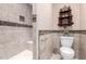 Bathroom showcasing a tiled shower with bench and decorative shelving unit at 9430 S 47Th Pl, Phoenix, AZ 85044