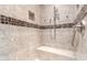 Modern bathroom featuring a tiled shower, bench, and built-in shelf at 9430 S 47Th Pl, Phoenix, AZ 85044