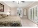 Bedroom featuring a large window, shuttered doors, and a ceiling fan at 9430 S 47Th Pl, Phoenix, AZ 85044