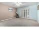 Comfortable bedroom featuring shuttered doors, neutral carpet, and soothing color palette at 9430 S 47Th Pl, Phoenix, AZ 85044