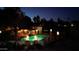 Inviting community pool and lounge area enhanced by ambient lighting at night for a relaxing atmosphere at 9430 S 47Th Pl, Phoenix, AZ 85044