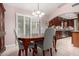 Dining room featuring a wooden table, chandelier, and access to the kitchen at 9430 S 47Th Pl, Phoenix, AZ 85044