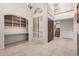 Welcoming entryway with tile floors, arched window, and built-in shelving; leads to stairs at 9430 S 47Th Pl, Phoenix, AZ 85044