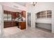 Spacious kitchen with wooden cabinetry, granite countertops, and a convenient built-in desk area at 9430 S 47Th Pl, Phoenix, AZ 85044
