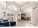 Open living room with high ceilings, tiled floors, and access to the dining area at 9430 S 47Th Pl, Phoenix, AZ 85044