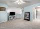 Spacious living room with carpet, tv, and bookcase with plenty of natural light at 9430 S 47Th Pl, Phoenix, AZ 85044