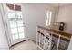 Staircase leading to a bright landing with a door to a balcony and shuttered window at 9430 S 47Th Pl, Phoenix, AZ 85044