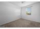 Neutral carpeted bedroom features a window with blinds and overhead light at 11626 E Yeager Cyn, Gold Canyon, AZ 85118