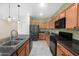 Fully equipped kitchen with black appliances, wooden cabinets, and modern fixtures at 11626 E Yeager Cyn, Gold Canyon, AZ 85118