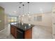 Kitchen island with sink, pendant lighting, and view into the living room and backyard at 11626 E Yeager Cyn, Gold Canyon, AZ 85118