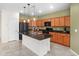 Modern kitchen features a black refrigerator, island with sink, and well-lit cabinets at 11626 E Yeager Cyn, Gold Canyon, AZ 85118