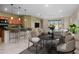 Open concept with dining area and a sleek black table and modern chairs at 11626 E Yeager Cyn, Gold Canyon, AZ 85118