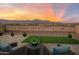 Inviting patio features cozy seating and serene views of the surrounding landscape at sunset at 11626 E Yeager Cyn, Gold Canyon, AZ 85118