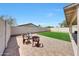 Spacious backyard featuring a brick patio, artificial grass, and secure fencing at 13443 W Post Dr, Surprise, AZ 85374
