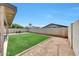 Expansive backyard showcasing artificial grass, brick accents, and privacy walls at 13443 W Post Dr, Surprise, AZ 85374