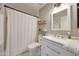 Bathroom with updated fixtures, shower curtain, and modern vanity at 13443 W Post Dr, Surprise, AZ 85374