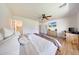 Bedroom with ceiling fan, tv, and access to bathroom at 13443 W Post Dr, Surprise, AZ 85374