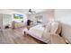 Bright bedroom with white walls, wood floors, large windows, and a ceiling fan at 13443 W Post Dr, Surprise, AZ 85374