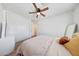 Bedroom with ceiling fan and closet with sliding doors at 13443 W Post Dr, Surprise, AZ 85374