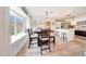 Cozy dining area with large window, wood table, and seamless access to the updated kitchen at 13443 W Post Dr, Surprise, AZ 85374