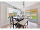 Bright dining area with a large table, backyard access, and a tranquil outdoor view at 13443 W Post Dr, Surprise, AZ 85374