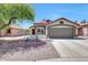 Attractive single-story home with a two-car garage, xeriscape front yard and covered entryway at 13443 W Post Dr, Surprise, AZ 85374