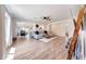 Bright and airy living room featuring wood-like floors, a ceiling fan, and seamless flow to other rooms at 13443 W Post Dr, Surprise, AZ 85374