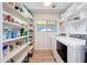 Walk-in pantry with shelving and laundry machines at 13443 W Post Dr, Surprise, AZ 85374