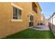 A cozy backyard with synthetic grass, pavers, and string lights overhead at 1367 S Country Club Dr # 1320, Mesa, AZ 85210