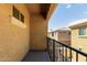 A balcony view of a house with an orange exterior and dark iron railing at 1367 S Country Club Dr # 1320, Mesa, AZ 85210