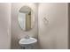 Cozy powder room features a pedestal sink, oval mirror, and neutral paint at 1367 S Country Club Dr # 1320, Mesa, AZ 85210