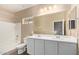 Bathroom featuring double sink vanity, large mirror, wood look flooring, and shower tub at 1367 S Country Club Dr # 1320, Mesa, AZ 85210