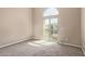 A bedroom with tan carpet and walls plus a large sliding glass door to a balcony at 1367 S Country Club Dr # 1320, Mesa, AZ 85210