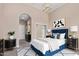Stylish bedroom with a blue upholstered bed, elegant furnishings, and neutral decor at 1367 S Country Club Dr # 1320, Mesa, AZ 85210