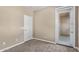 This bedroom has neutral walls, carpet and a patio door leading to the outside at 1367 S Country Club Dr # 1320, Mesa, AZ 85210