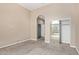 Bedroom featuring tan carpet, tan walls, and a closet with mirrored doors at 1367 S Country Club Dr # 1320, Mesa, AZ 85210