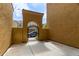Private courtyard with an arched entry, featuring a neutral palette and an open space at 1367 S Country Club Dr # 1320, Mesa, AZ 85210