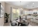 Cozy dining area featuring modern lighting, a dark wood table, and a bright view at 1367 S Country Club Dr # 1320, Mesa, AZ 85210