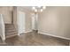 Bright dining room with tile floors, chandelier, and staircase leading to the second floor at 1367 S Country Club Dr # 1320, Mesa, AZ 85210