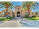Lush lawn and exterior of the community center with a circular facade and mature palm trees at 1367 S Country Club Dr # 1320, Mesa, AZ 85210