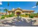 Community center with palm trees, mature landscaping, water feature, and circular driveway at 1367 S Country Club Dr # 1320, Mesa, AZ 85210
