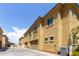 Townhouse showing tan paint, decorative metal and street view with exterior A/C unit at 1367 S Country Club Dr # 1320, Mesa, AZ 85210