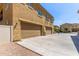 Townhouse with two-car garage and exterior showing tan paint, decorative metal, and gravel landscape at 1367 S Country Club Dr # 1320, Mesa, AZ 85210