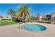 Relaxing community hot tub with a safety rail, set amidst palm trees and landscaped grounds at 1367 S Country Club Dr # 1320, Mesa, AZ 85210