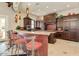 Luxurious kitchen with dark wood cabinets, a granite countertop island, and stainless steel appliances at 1367 S Country Club Dr # 1320, Mesa, AZ 85210