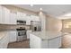 Modern kitchen with stainless steel appliances, white cabinets, and granite countertops on island at 1367 S Country Club Dr # 1320, Mesa, AZ 85210