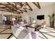 Living room featuring marble floors, vaulted ceilings, wooden beams, and modern furniture at 1367 S Country Club Dr # 1320, Mesa, AZ 85210