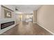 Open-concept living space featuring wood-look flooring and a modern fireplace with a kitchen island at 1367 S Country Club Dr # 1320, Mesa, AZ 85210