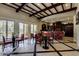 Lounge area with tables, chairs, tile floor, full bar, and dark wood coffered ceiling at 1367 S Country Club Dr # 1320, Mesa, AZ 85210
